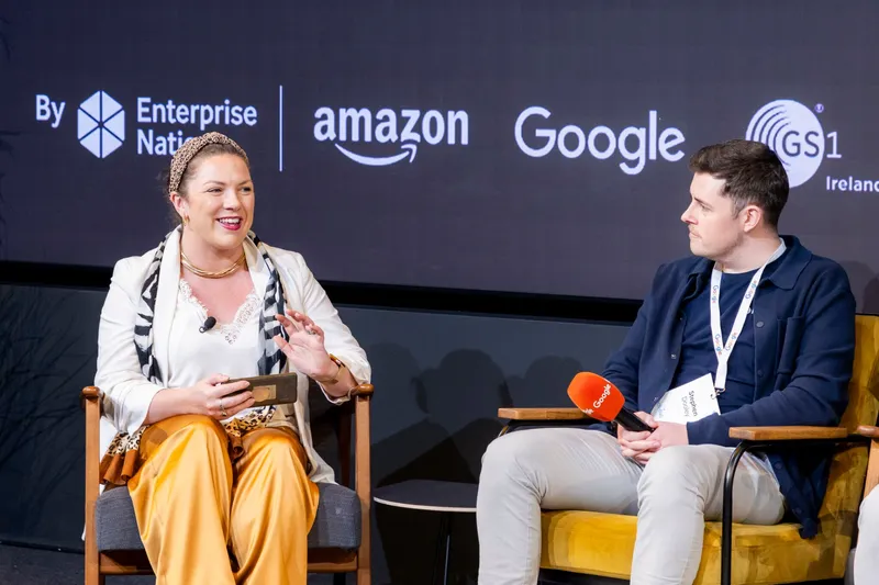 Tara Elzingre speaking on stage at an Enterprise Nation event with Amazon and Google